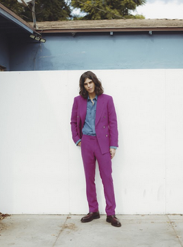 A model wearing a purple suit